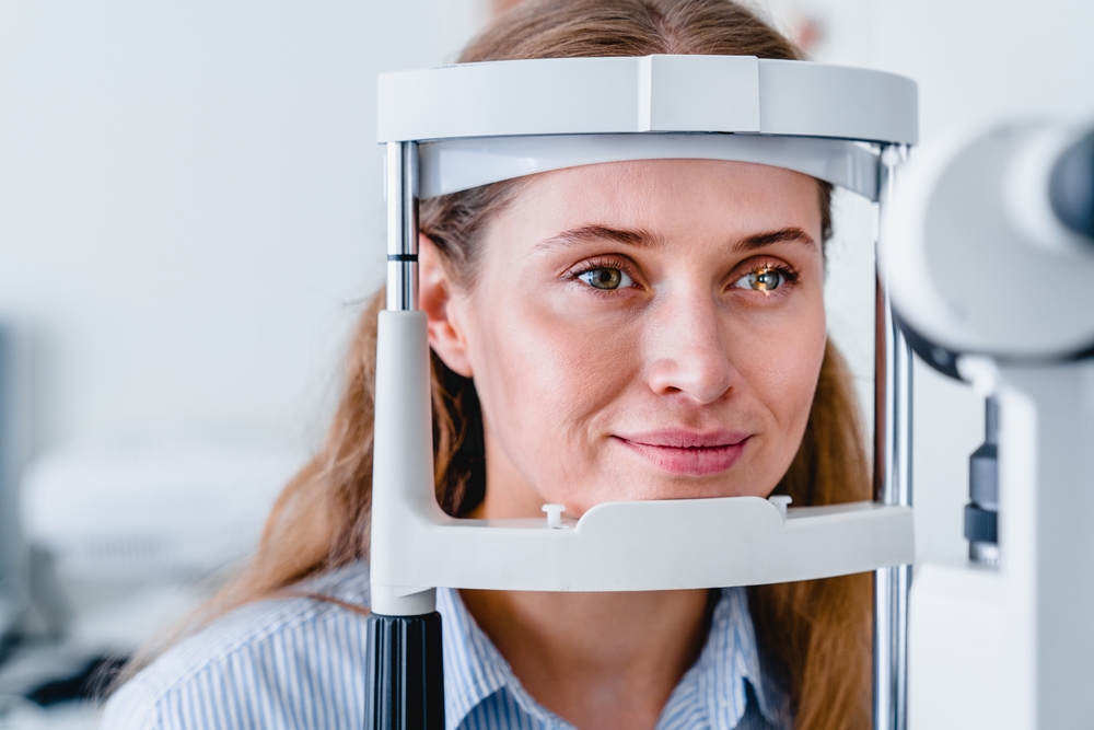 A woman sits comfortably during an eye screening using modern diagnostic equipment, highlighting the importance of routine eye health evaluations – Eye Doctor in Detroit.